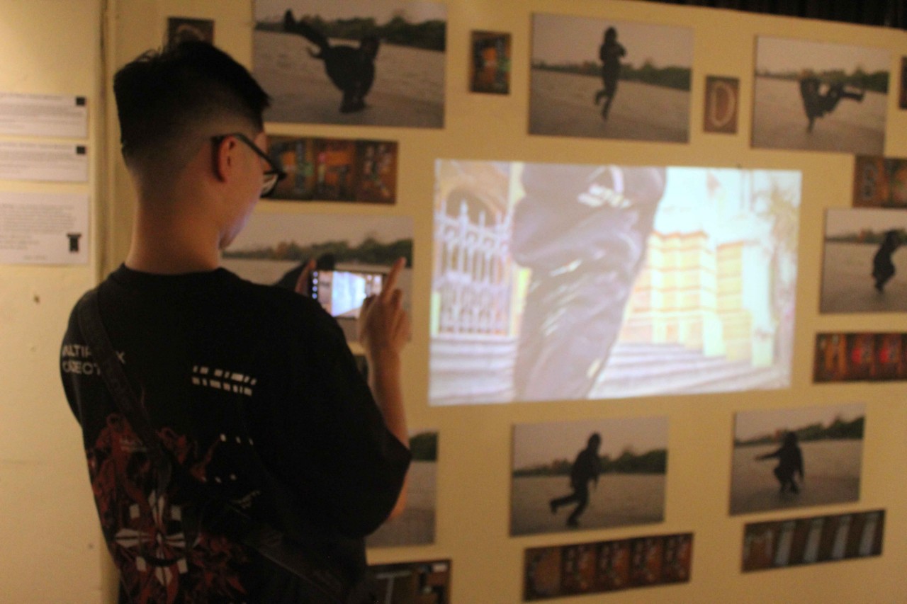 A visitor checks out the video and photography display (Photo: Jason Law)