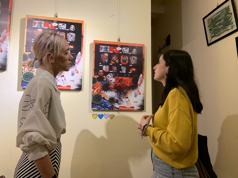 Artist Mary Grygoryan talks to a visitor about her Year of the Rat digital art (Photo courtesy of Duncan Griffiths)
