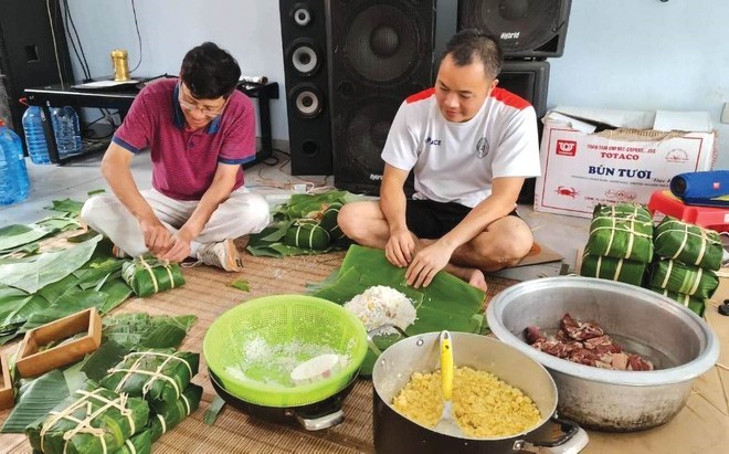 Vietnamese people make banh chung to celebrate Tet in Mozambique. Photo: VNA