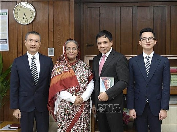 Vietnamese Ambassador to Bangladesh Pham Viet Chien (second from right) and embassy staff take a photo with the Prime Minister of Bangladesh Sheikh Hasina (third from right) in 2020. (Photo: VNA)
