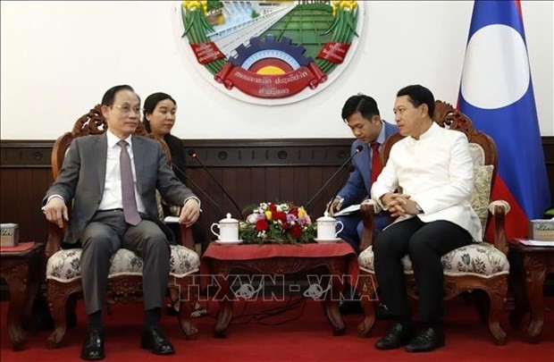 Deputy Prime Minister and Minister of Foreign Affairs of Laos Saleumxay Kommasith (R) receives Le Hoai Trung, member of the Communist Party of Vietnam (CPV) Central Committee and Chairman of its Commission for External Relations. Photo: VNA