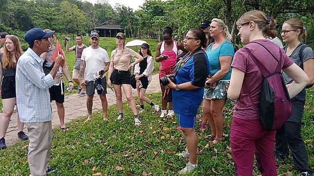A Vietnamese tour guide speaking to foreign tourists at Mỹ Sơn Sanctuary in the central province of Quang Nam. Photo: VNS