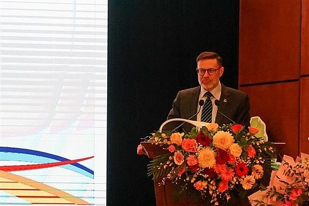 Australian Ambassador Andrew Goldzinowski addresses the event. (Photo: VNA)