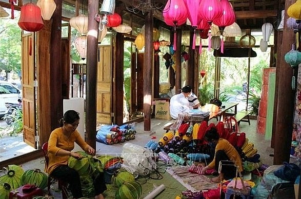 Locals produce lanterns in Hoi An ancient town.