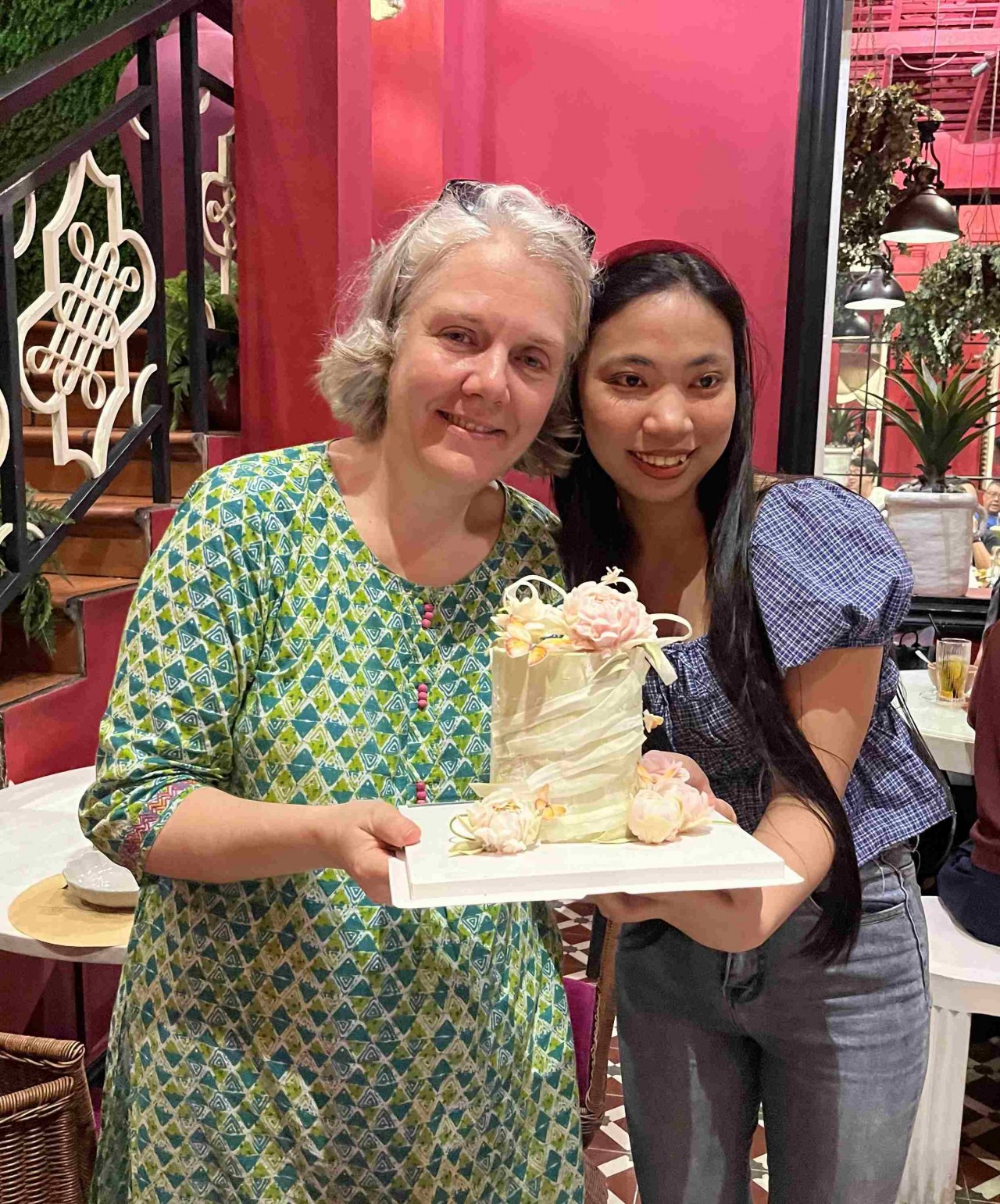 Florence Cavalier (left) receives a special gift - a cake made by a young woman once supported by EPVN. (Photo: Provided by the family)