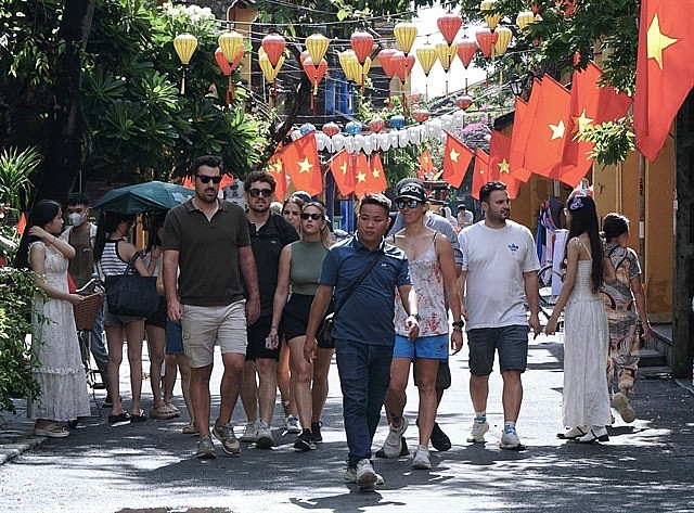 International tourists stroll on the streets of old town Hoi An. Photo: VNS