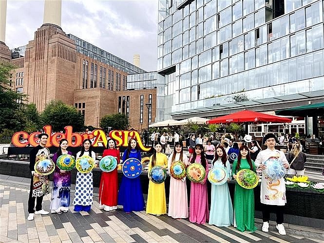 The Vietnamese delegation parades in traditional ao dai and conical hats along the streets of London. (Photo published by VNA) The Vietnamese delegation parades in traditional ao dai and conical hats along the streets of London. (Photo published by VNA)
