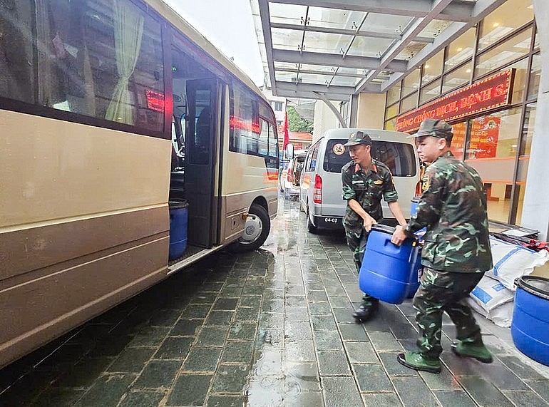 Military medical staff load Chloramin B – a water disinfectant chemical – onto a truck.