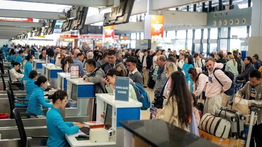 Passengers complete check-in procedures at Noi Bai International Airport in Hanoi.