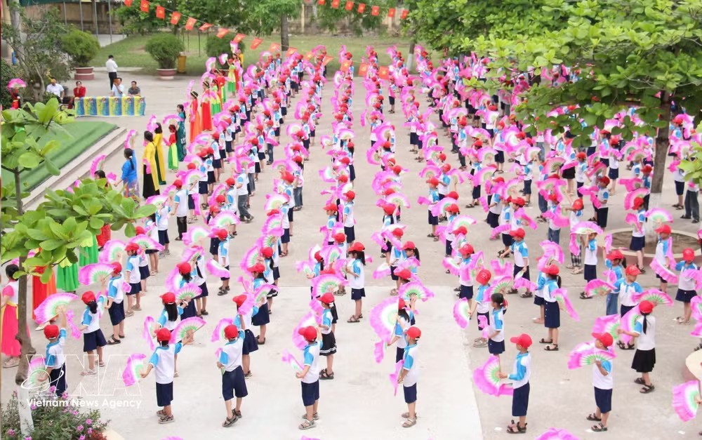 Teachers and students of Duy Nhat Primary School in Hung Yen province perform a mass folk dance. (Photo: VNA)