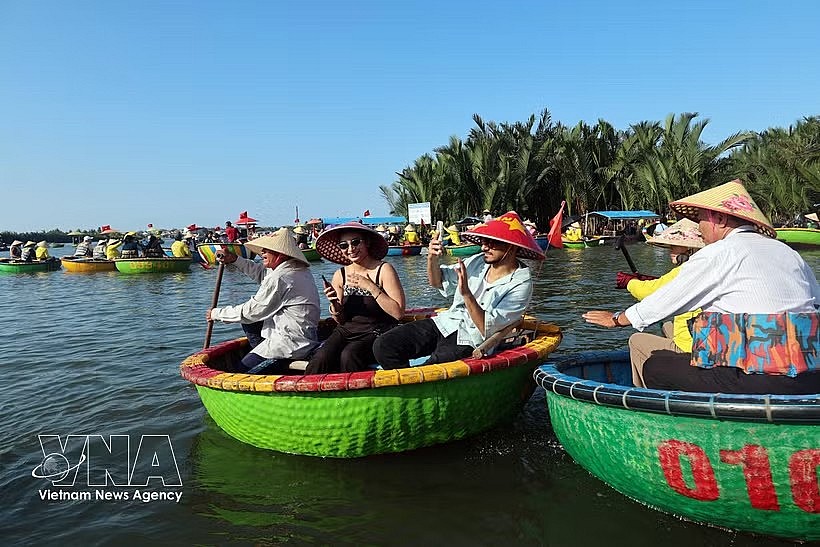 International visitors enjoy riding traditional basket boats through the coconut palm waterways of Cam Thanh village, named among the world's 50 most beautiful villages in 2025. (Photo: VNA)