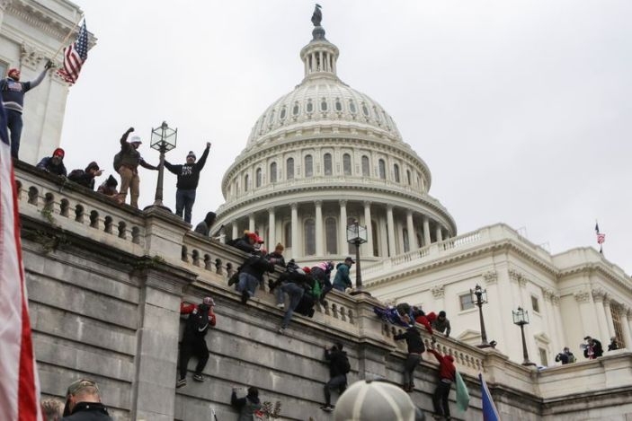 Supporters of U.S. President Donald Trump climb on walls at the U.S. Capitol during a protest against the certification of the 2020 U.S. presidential election results by the U.S. Congress, in Washington, U.S., January 6, 2021 (Photo: Reuters)  