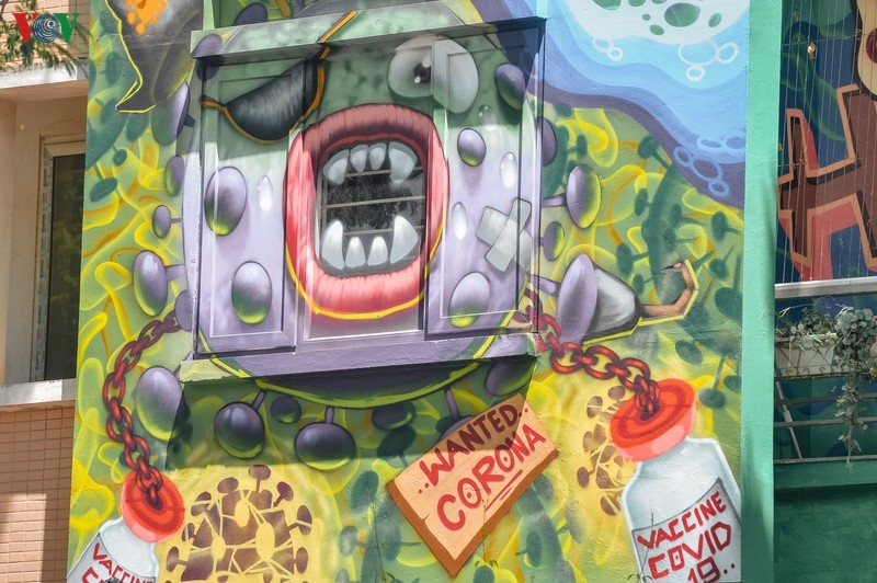 Artful masion in Hanoi with COVID-19-themed communication graffiti catches attention artful masion in hanoi with covid 19 themed propoganda graffiti catches attention