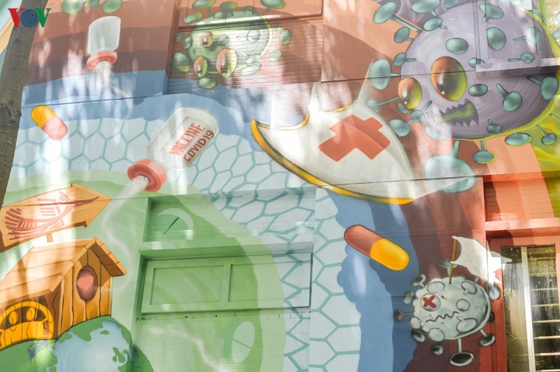 Artful masion in Hanoi with COVID-19-themed communication graffiti catches attention artful masion in hanoi with covid 19 themed propoganda graffiti catches attention