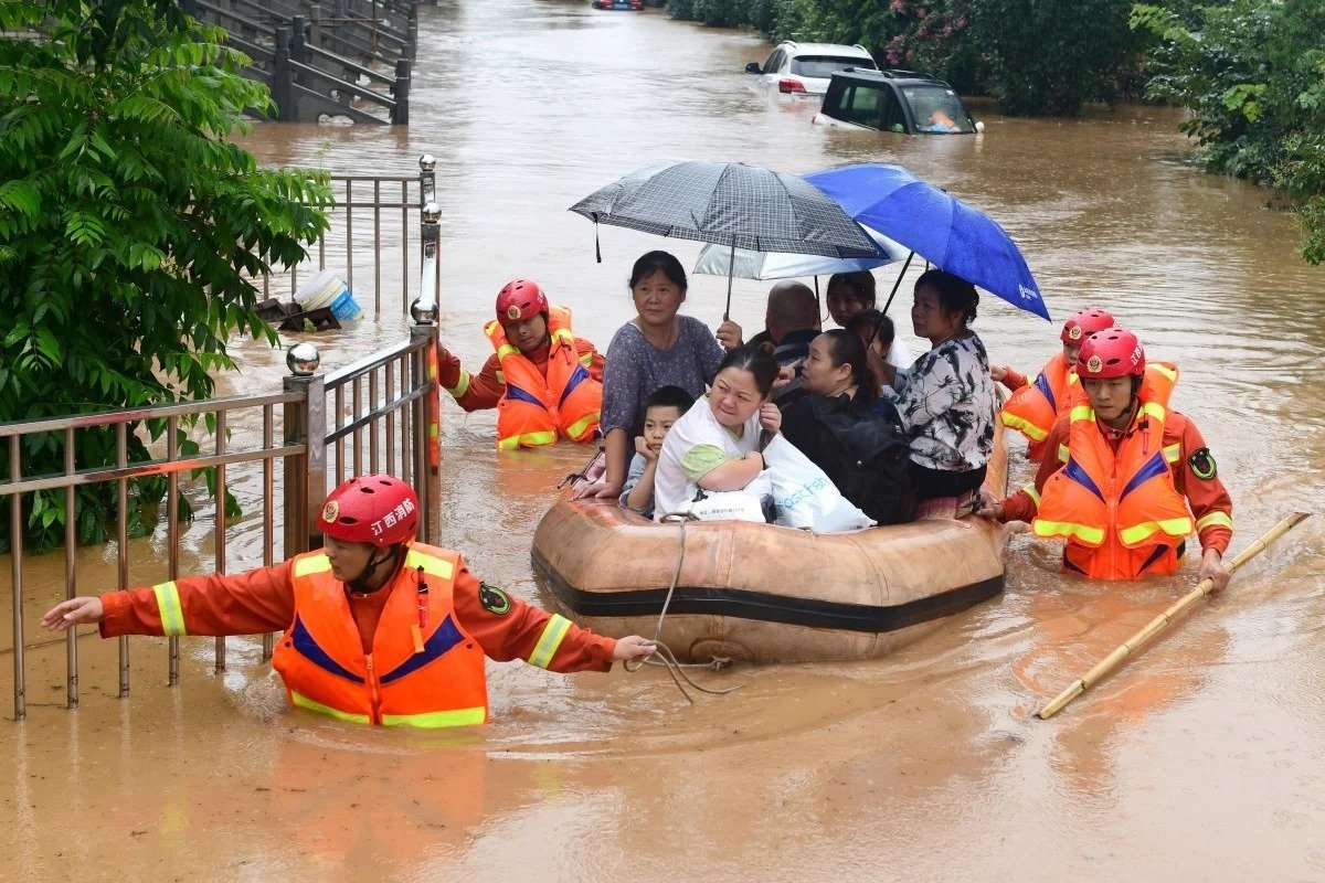 Rescuers tow a raft filled with evacuated residents through floodwaters in china's jiangxi province on wednesday.