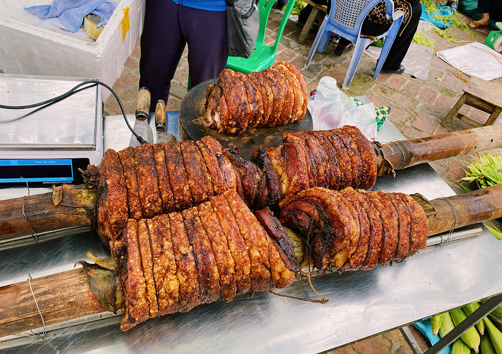 Famous Crispy Pork Roasted on Carrying Poles in Duong Lam Ancient Village
