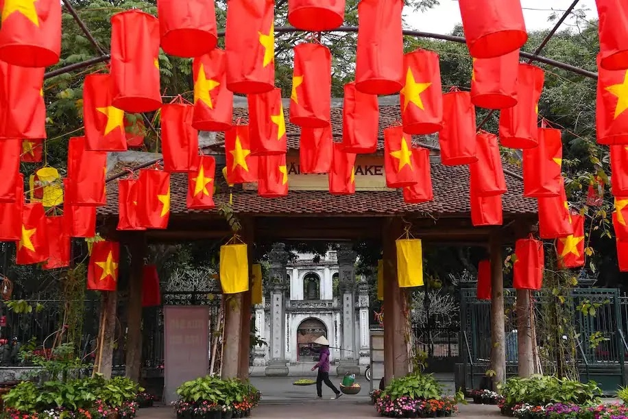 A food vendor walks past the Temple of Literature in Hanoi on Feb. 3. (Nhac Nguyen/AFP/Getty Images)