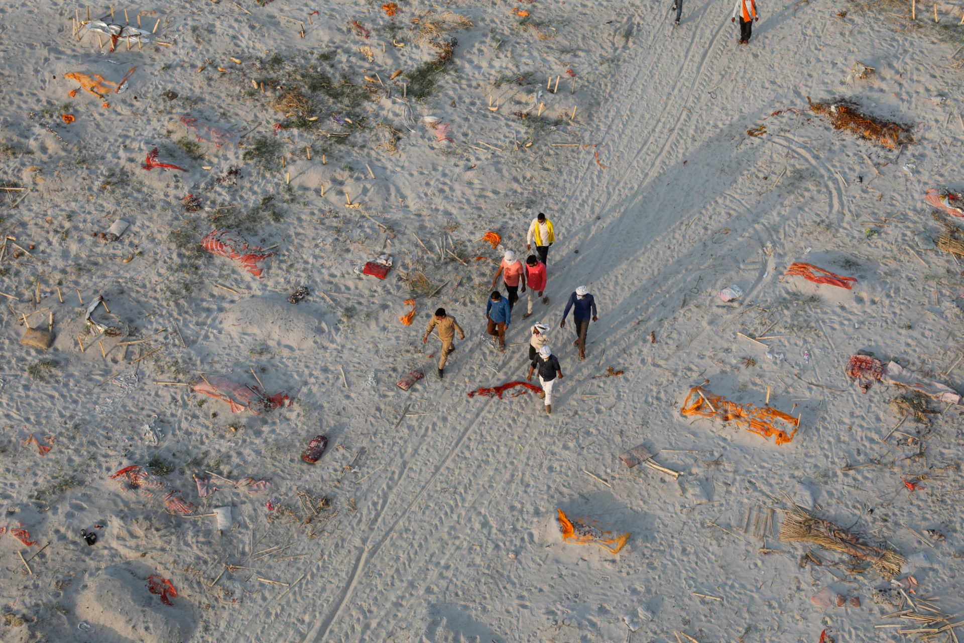 Bodies of suspected Covid-19 victims are seen in shallow graves buried in the sand near a cremation ground on the banks of Ganges River in Prayagraj, India on Saturday.Rajesh Kumar Singh / AP