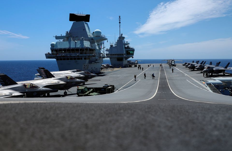  F-35B Lightning II aircrafts are seen on the deck of the HMS Queen Elizabeth aircraft carrier offshore Portugal, May 27, 2021. Picture taken through the window. REUTERS/Bart Biesemans