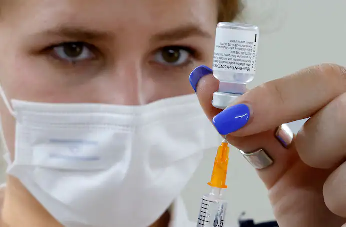 An Israeli medical worker prepares a dose of the Pfizer-BioNTech coronavirus vaccine in Tel Aviv on July 5. (Jack Guez/AFP/Getty Images)