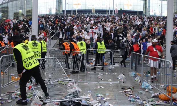 Stewards replace barricades after they were knocked over by supporters outside Wembley during the Euro 2020 final. Photograph: David Cliff/AP