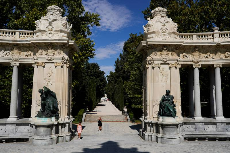 A woman takes pictures at El Retiro Park on the day that Unesco added Madrid's historic Paseo del Prado boulevard and Retiro Park to its list of World Heritage Sites (JUAN MEDINA/Reuters)
