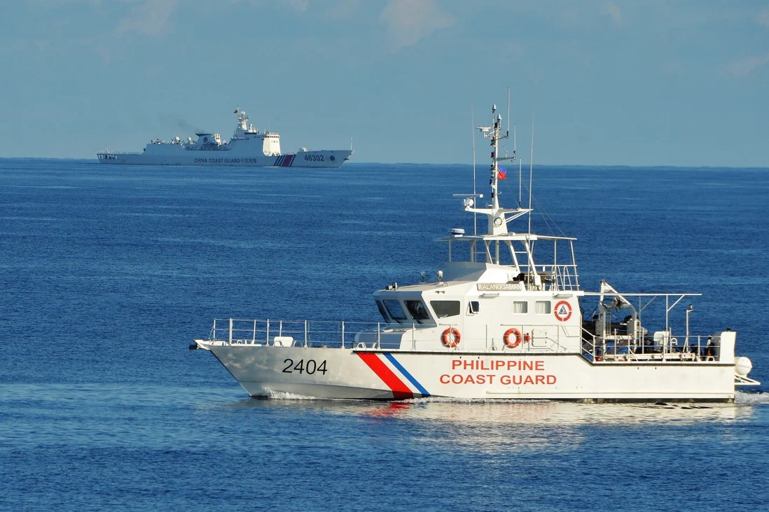 A Philippine coastguard ship and a Chinese coastguard ship pass each other near Scarborough Shoal in the South China Sea. Photo: AFP