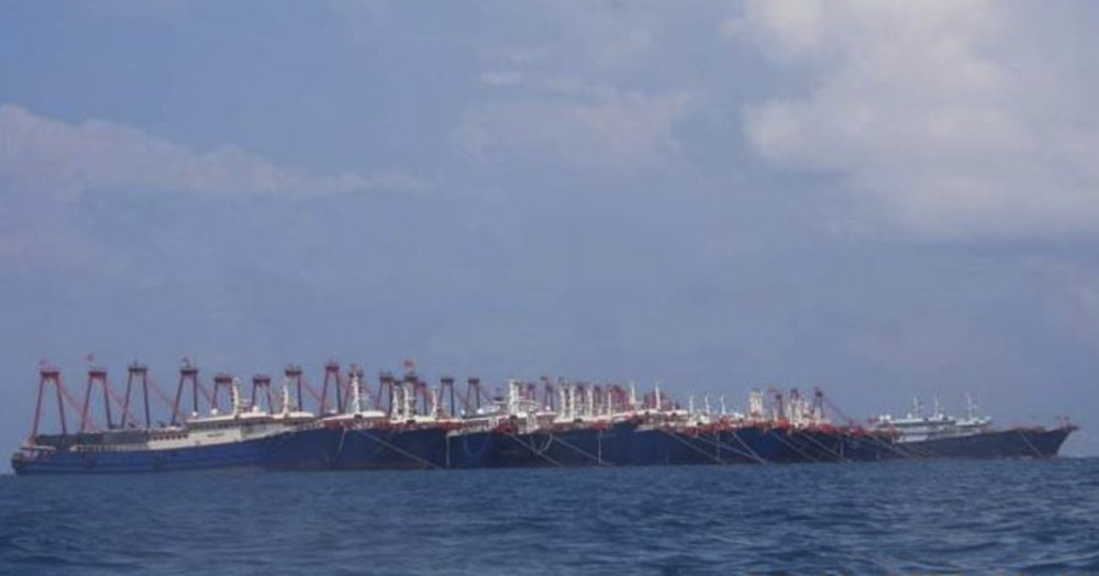 In this March 7, 2021, file photo provided by the Philippine Coast Guard/National Task Force-West Philippine Sea, some 220 Chinese vessels are seen moored at Whitsun Reef, South China Sea. The Philippine government has summoned the Chinese ambassador to press a demand for Chinese vessels to immediately leave the reef claimed by Manila in the disputed South China Sea and said the illegal presence was stoking regional tension, the Department of Foreign Affairs said Tuesday, April 13, 2021. (National Task Force-West Philippine Sea via AP, File)