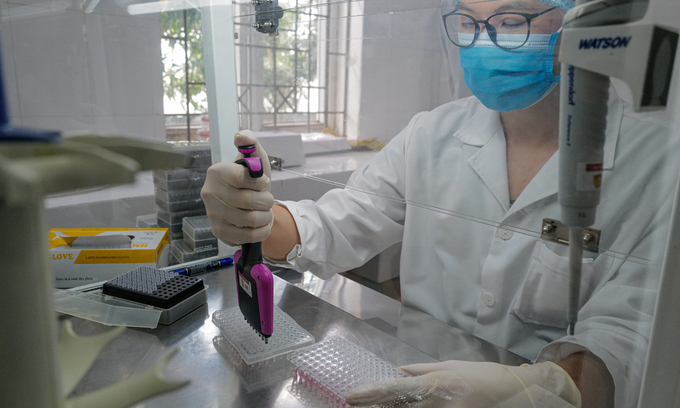 A medic works on samples taken for the new coronavirus test at a lab in Bac Giang Province, May 29, 2021.