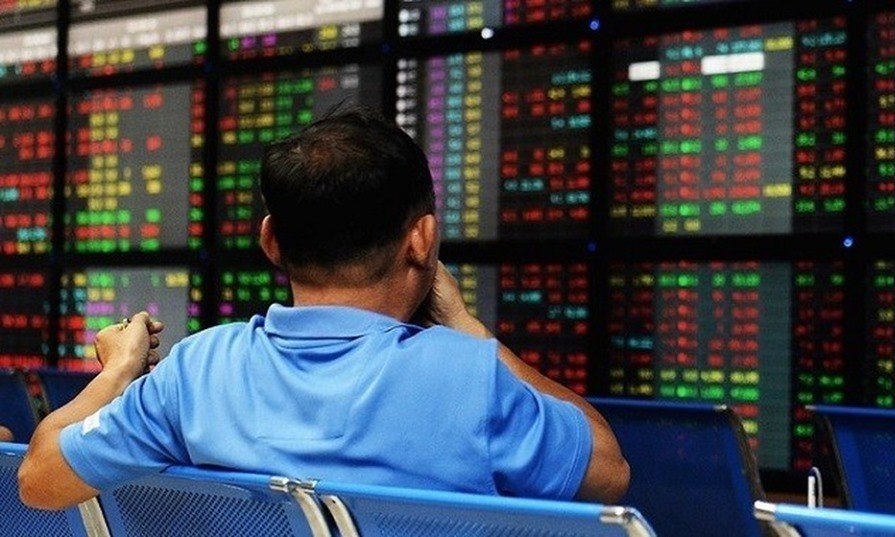 An investor watches stock prices at a brokerage office in Hanoi. Photo by AFP.