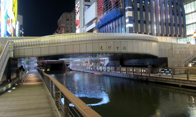 The pedestrian riverside area of Ebisu Bridge crossing Dotonbori River in Chuo Ward of Osaka City. Photo by Flickr/Wally Gobetz.