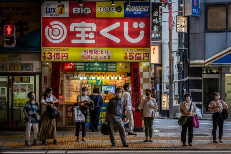 People wearing face masks wait to cross a street on July 28, 2021 in Tokyo, Japan. Tokyo metropolitan government reported 3,177 new coronavirus cases on Tuesday, an increase on yesterday and the highest number of infections recorded so far for the city. Yuichi Yamazaki—Getty Images