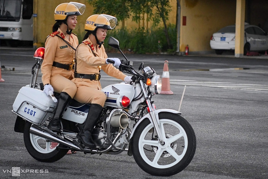 Vietnamese traffic policewomen exercise to lead groups of delegation by powerful motorcycles. Vietnamese traffic police women exercise to lead groups of delegation by powerful motorcycles.