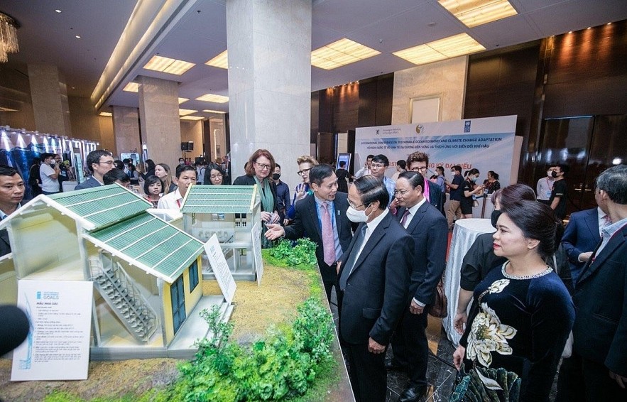Delegates visit models of flood-resistant houses at the event. Photo: VNA
