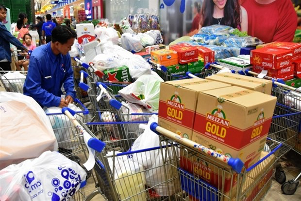 An employee from a supermarket in HCM City delivers goods to customers. (Photo congthuong.vn)
