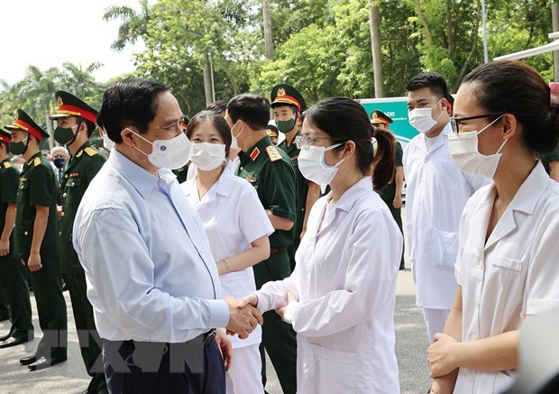 Prime Minister Pham Minh Chinh talks to health workers at the campaign launch on July 10. Photo: VNA