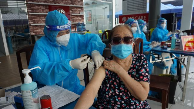 A local resident in HCM City is vaccinated against Covid-19. Photo: VNA/VNS