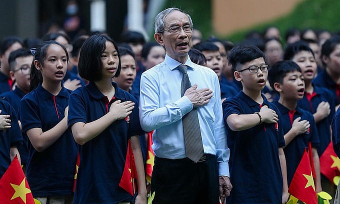 Nguyen Xuan Khang, principal of the Marie Curie school in Hanoi, stands with his students in the opening ceremony of a new school year on September 5, 2020. Photo: VnExpress
