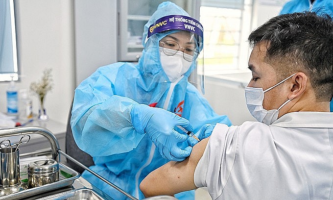 A man receives a Covid-19 vaccine shot in Hanoi, March 8, 2021. Photo: VnExpress